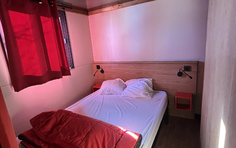 Double bedroom of the Roulotte, unique accommodation in Auvergne, for rent at Les Murmures du Lignon campsite
