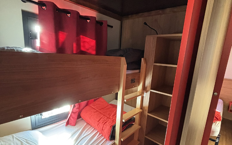 Double bedroom of the Roulotte, unique accommodation in Auvergne, for rent at Les Murmures du Lignon campsite