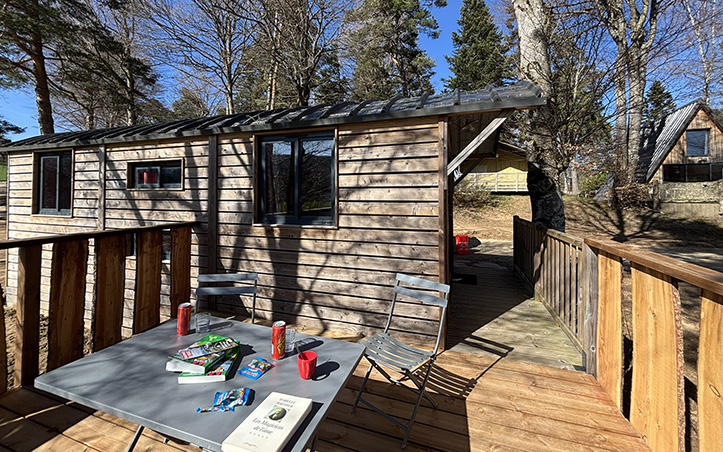 Exterior view of the Roulotte with terrace, unique accommodation in Haute-Loire, for rent at Les Murmures du Lignon campsite