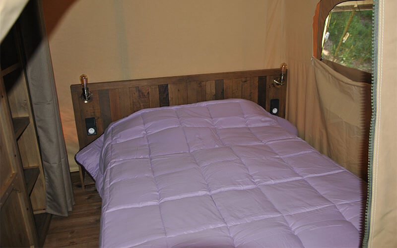 Room with double bed from the Safari Trappeur tent, unusual accommodation for rent near Le Puy-en-Velay